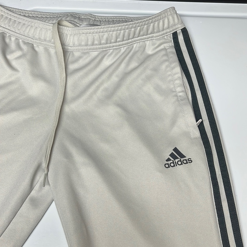 Adidas track pants , cream / gray stripes